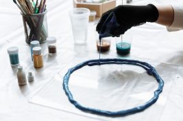 a-person-pouring-resin-on-a-mold